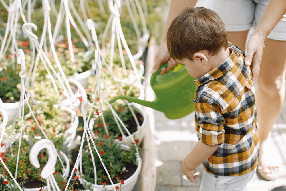 focus-little-boy-mom-her-son-with-green-watering-can-greenhouse